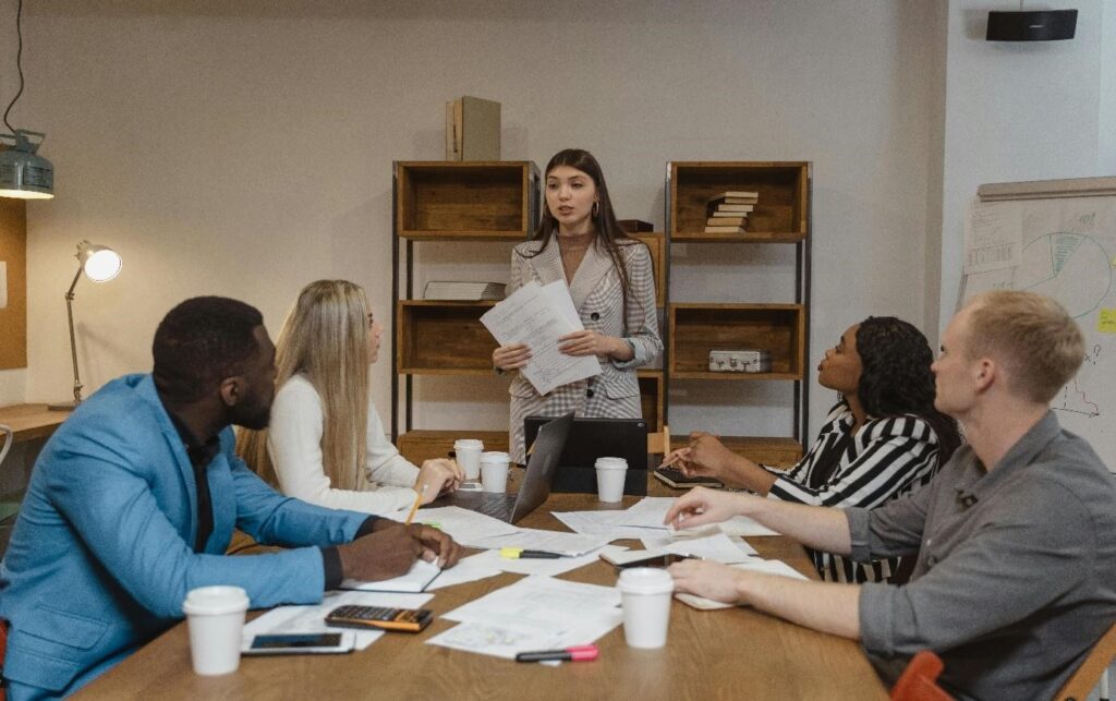 How Can Non-technical Clients Effectively Set Project Goals, Timelines, and Milestones for Successful Project Management? 3 Someone communicating with a tech team